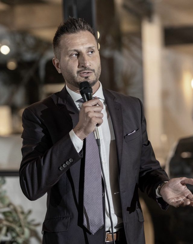 Asim Khan speaking at an event