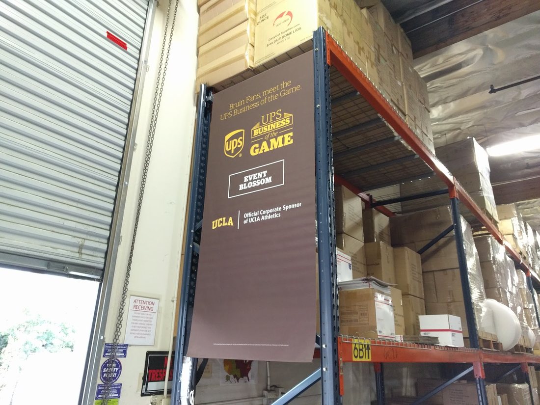 UPS Business of the Game banner hanging in the Event Blossom warehouse